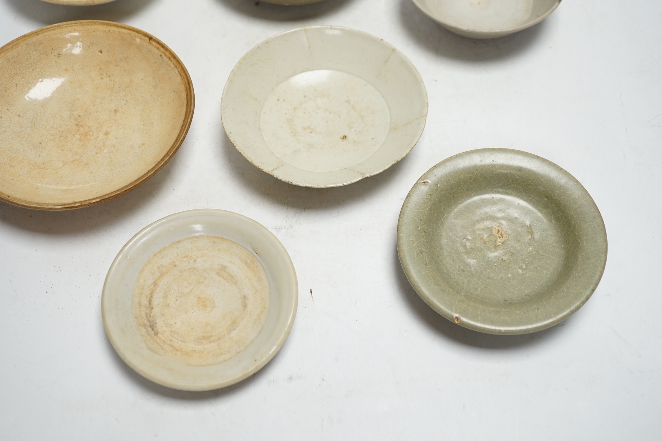 A group of seven Chinese Ding type, qingbai and celadon dishes, Song-Yuan dynasty, largest 15.5cm